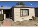 Single-story home featuring a cozy front entrance and classic design with window at 110 E 8Th St, Casa Grande, AZ 85122