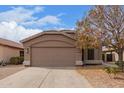 Charming single-story home with a well-maintained front yard, a two-car garage and desert landscaping at 1148 S Sierra St, Gilbert, AZ 85296