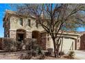 Two story home with desert landscaping, stone accents, and a two car garage at 12132 W Ashby Dr, Peoria, AZ 85383