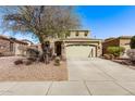 Charming two-story home featuring a two-car garage and desert landscaping at 12132 W Ashby Dr, Peoria, AZ 85383