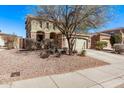 Two-story home featuring a two-car garage, desert landscaping, and sidewalk at 12132 W Ashby Dr, Peoria, AZ 85383