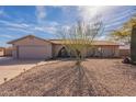 Charming single-story home with desert landscaping, attached garage, and unique architectural details at 14493 S Country Club Dr, Arizona City, AZ 85123