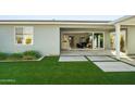 View of the backyard with manicured artificial turf and patio at 17192 W Rocklin St, Surprise, AZ 85388