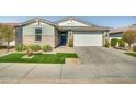 Charming single-story home boasts manicured landscaping, a two-car garage, and excellent curb appeal at 17192 W Rocklin St, Surprise, AZ 85388