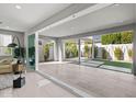 Covered patio features modern tile flooring and a view of the well maintained backyard at 17192 W Rocklin St, Surprise, AZ 85388