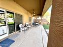 Covered patio featuring neutral toned concrete, chairs, ceiling fan and lights, and view of a fenced backyard at 17420 W Mohave St, Goodyear, AZ 85338