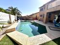 Backyard showcasing a refreshing pool, patio area with outdoor seating, and lush landscaping at 17420 W Mohave St, Goodyear, AZ 85338