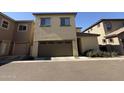 View of a beige two-story home with a brown garage door and minimal landscaping at 1743 W Pollack St, Phoenix, AZ 85041