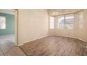 Dining room with wood-look flooring and plenty of natural light at 17813 W Primrose Ln, Surprise, AZ 85374