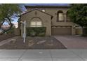 Elegant two-story home with a private balcony, a two-car garage, and a brick driveway at 18256 W Carol Ave, Waddell, AZ 85355