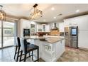 Spacious kitchen with modern appliances, white cabinets, and a center island with seating at 18256 W Carol Ave, Waddell, AZ 85355