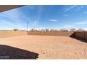 Large, empty backyard with a block wall, ready for customization at 18783 N Avelino Dr, Maricopa, AZ 85138