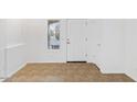 Bright entryway with a tile floor, white walls and a window for natural light at 1911 E Hartford Ave, Phoenix, AZ 85022