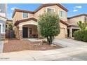 Exterior features a covered entry and front patio, desert landscaping with a young tree at 1911 E Hartford Ave, Phoenix, AZ 85022