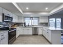 Bright kitchen featuring stainless steel appliances, white cabinets and quartz countertops at 19236 N 22Nd Ln, Phoenix, AZ 85027