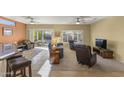 Cozy living room with neutral tones, comfortable seating, and ample natural light from sliding glass doors at 19460 N Hidden Canyon Dr, Surprise, AZ 85374