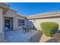 Secluded patio area featuring a table with four chairs, perfect for enjoying outdoor living at 19460 N Hidden Canyon Dr, Surprise, AZ 85374