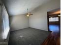 The spacious living room features new carpet, a ceiling fan, and neutral paint at 1954 W Kerry Ln, Phoenix, AZ 85027