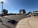 A view of the street, showing a quiet residential neighborhood with several parked cars at 1954 W Kerry Ln, Phoenix, AZ 85027