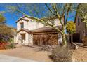 Attractive two-story home with desert landscaping, a tiled roof, and a two-car garage at 2406 W Tallgrass Trl, Phoenix, AZ 85085