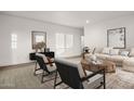 A living room design featuring neutral furniture, layered rugs, and bright, natural light at 2723 S 357Th Dr, Tonopah, AZ 85354