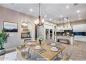 Eat-in kitchen and dining room featuring an open layout, modern style, and lots of natural light at 28826 N 67Th Dr, Peoria, AZ 85383