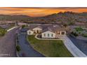 Stunning home with manicured lawn, mature trees, and a circular driveway leading to a three-car garage at 297 W Chase St, San Tan Valley, AZ 85143