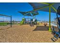 Community playground with slides, swings, and climbing equipment under blue skies at 3207 E Ranchhand Dr, San Tan Valley, AZ 85140