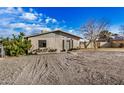 Charming single-story home showcasing a gravel front yard, cozy front porch and neutral color palette at 330 W Northern Ave, Coolidge, AZ 85128