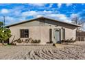 Charming single-story home showcasing a gravel front yard, cozy front porch and neutral color palette at 330 W Northern Ave, Coolidge, AZ 85128