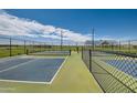 Community pickleball courts, an amenity of this residential neighborhood, set against a backdrop of blue skies at 3382 E Saddletree Way, San Tan Valley, AZ 85140