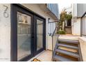 Condo exterior features French doors, a small staircase, and a metal railing, creating an inviting entrance at 3416 N 44Th St # 70, Phoenix, AZ 85018