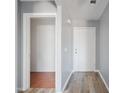 Welcoming hallway with gray walls, wood-look vinyl plank flooring, and neutral trim is ready for your design touches at 3545 N Hohokam Dr, Eloy, AZ 85131