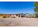 Exterior shot of home showing ample parking, covered carport, and low-maintenance desert landscaping at 417 W Sunset Dr, Mammoth, AZ 85618