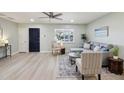 Open-concept living room with a gray sectional sofa, accent chair, and modern decor at 4235 N 16Th Dr, Phoenix, AZ 85015