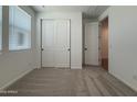 Bright bedroom featuring a closet and an entryway to a hallway at 4513 W 95Th Dr, Tolleson, AZ 85353