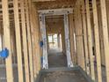 View of the framed entryway of the house with visible wall studs and concrete flooring at 4513 W 95Th Dr, Tolleson, AZ 85353