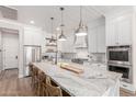 Spacious kitchen features an oversized island, stainless appliances, and custom white cabinetry at 4675 S Bandit Rd, Gilbert, AZ 85297