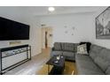 Comfortable living room with gray sectional, modern decor, and plenty of natural light at 4754 N 14Th St, Phoenix, AZ 85014