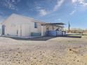 Exterior shot of a single Gathering home featuring an outdoor kitchen, bar, and desert landscaping at 48822 N Roughrider Rd, New River, AZ 85087