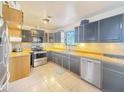 Bright kitchen featuring stainless steel appliances, tiled floors, and wood cabinets at 48822 N Roughrider Rd, New River, AZ 85087