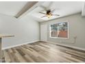 Bright living room with stylish wood-look floors, a large window, and a ceiling fan providing great natural light at 510 N Alma School Rd # 103, Mesa, AZ 85201