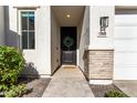 Inviting front entrance with a decorative wreath, stylish lighting and brick accents at 5460 S Dillon Cir, Mesa, AZ 85212