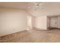 Spacious living room featuring vaulted ceilings, neutral walls, a ceiling fan, and open access to other rooms at 6132 E Casper St, Mesa, AZ 85205