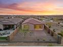 Aerial view of the backyard with desert landscaping, perimeter fence, and covered patio at 7165 S Bruins Rd, Gold Canyon, AZ 85118