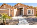 Inviting home with a walkway leading to the front entrance, complemented by desert landscaping and neutral tones at 723 W Canary Way, Chandler, AZ 85286