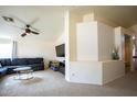 Comfortable living room with a ceiling fan, a decorative accent wall, and neutral-colored carpet at 723 W Canary Way, Chandler, AZ 85286