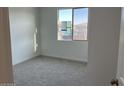 Cozy bedroom with carpet flooring, a window offering natural light, and fresh paint at 7654 W Tether Trl, Peoria, AZ 85383