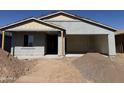 New construction home with a two-car garage and covered porch ready for customization at 9618 W Parkway Dr, Tolleson, AZ 85353