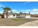 Single-story home featuring xeriscaping, artificial lawn, and a two-car garage at 10013 N 56Th Dr, Glendale, AZ 85302